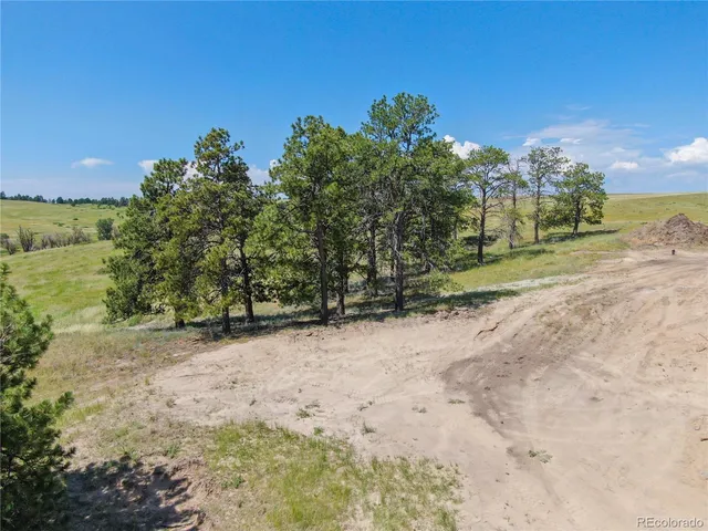 a view of a house with a yard covered in snow