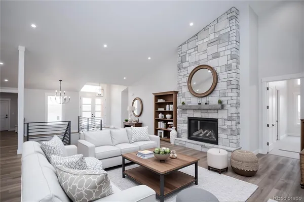 a living room with furniture a fireplace a rug and a window
