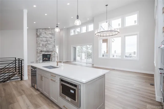 a kitchen that has a lot of cabinets and wooden floor