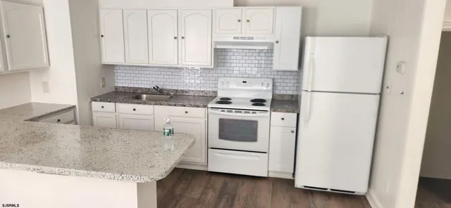 a white refrigerator freezer sitting inside of a kitchen