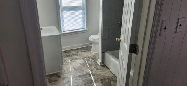 a bathroom with a tub and shower