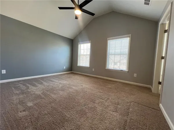 an empty room with a empty space and windows