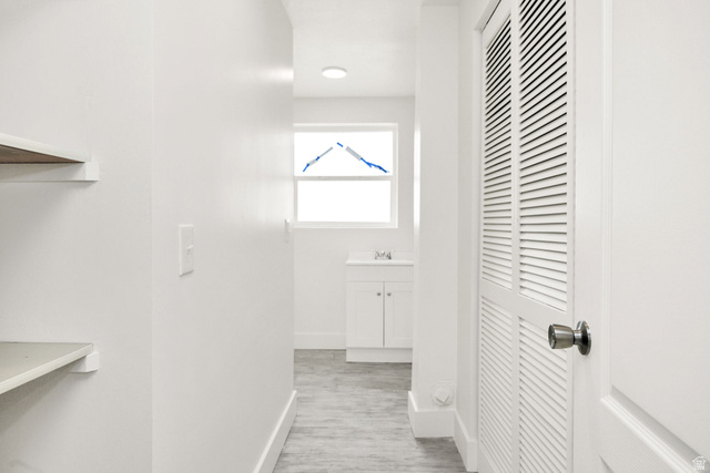 4155 Johnson Road Nibley, UT 84321 - Photo 35 of 71 Corridor with baseboards and light wood-style flooring