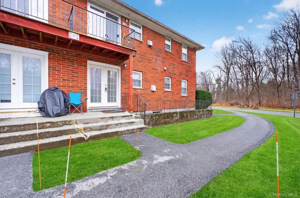 a front view of a house with garden and plants