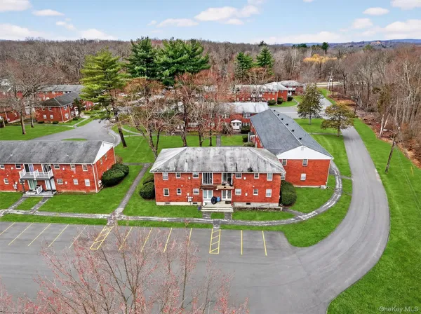 an aerial view of a house with a garden and lake view