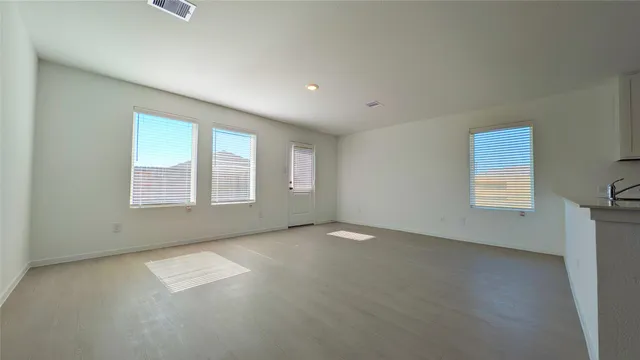 an empty room with a empty space and windows