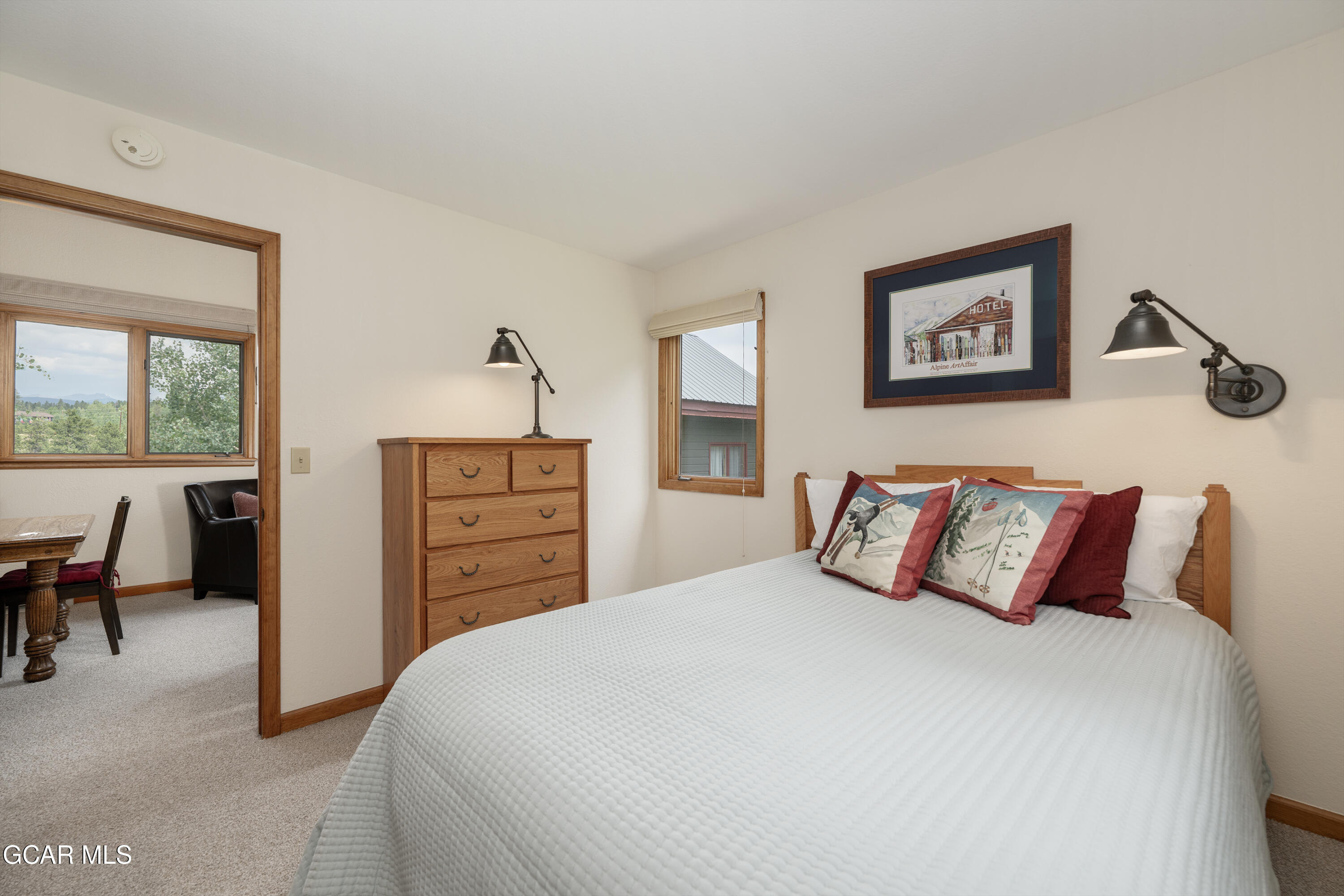 820 Wolverine Lane, Unit 3 Fraser, CO 80442 - Photo 17 of 43 a bedroom with a bed and a dresser next to a window