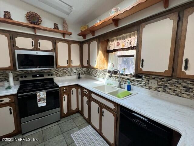 8 North Trident Place St. Augustine, FL 32080 - Photo 14 of 26 a kitchen with a sink stove and microwave