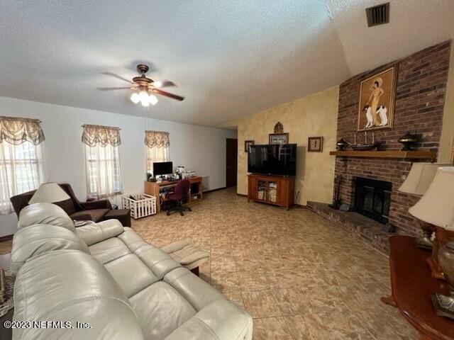 8 North Trident Place St. Augustine, FL 32080 - Photo 5 of 26 a living room with furniture a fireplace and a flat screen tv