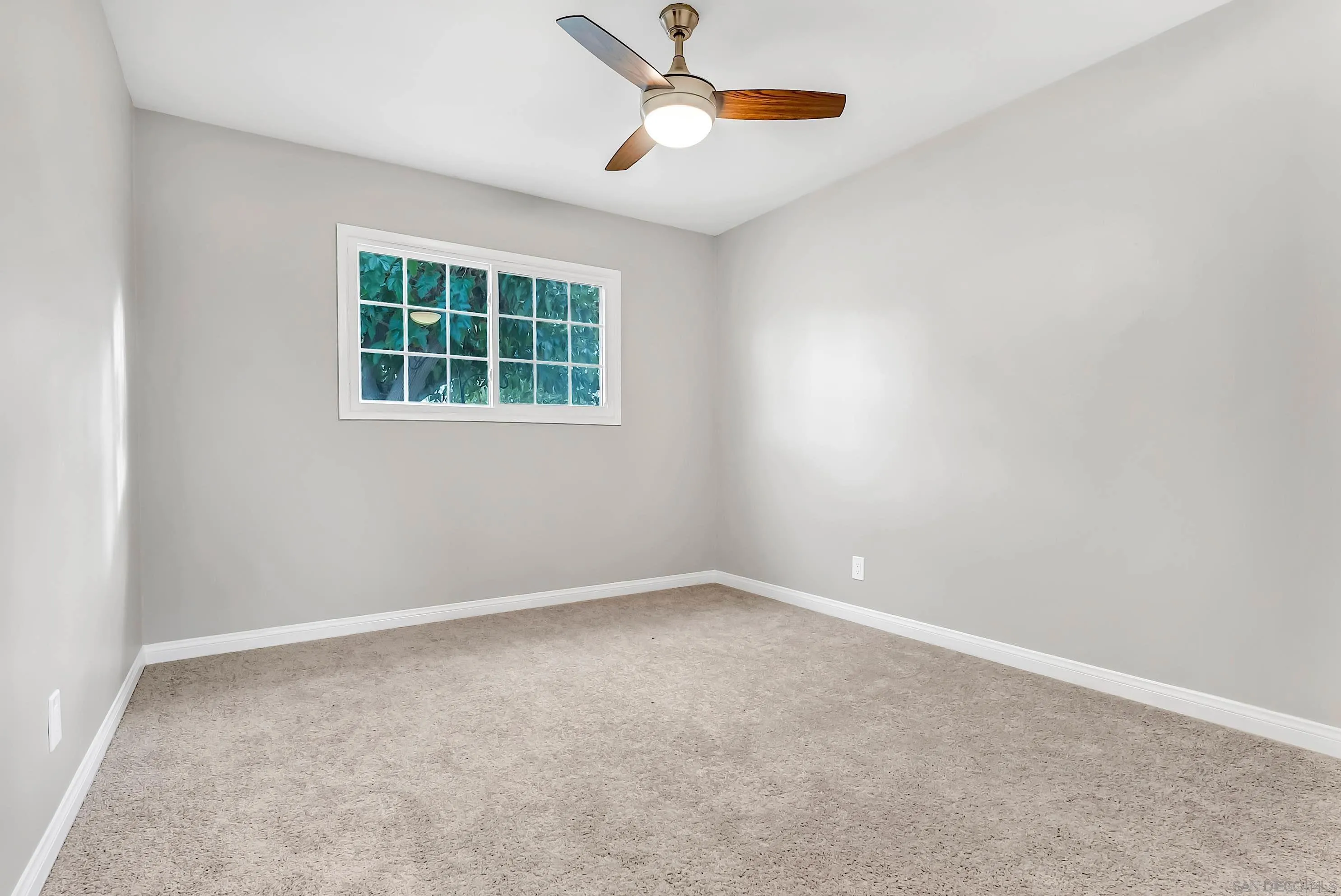 9215 Lake Canyon Road Santee, CA 92071 - Photo 13 of 18 an empty room with a window and a ceiling fan