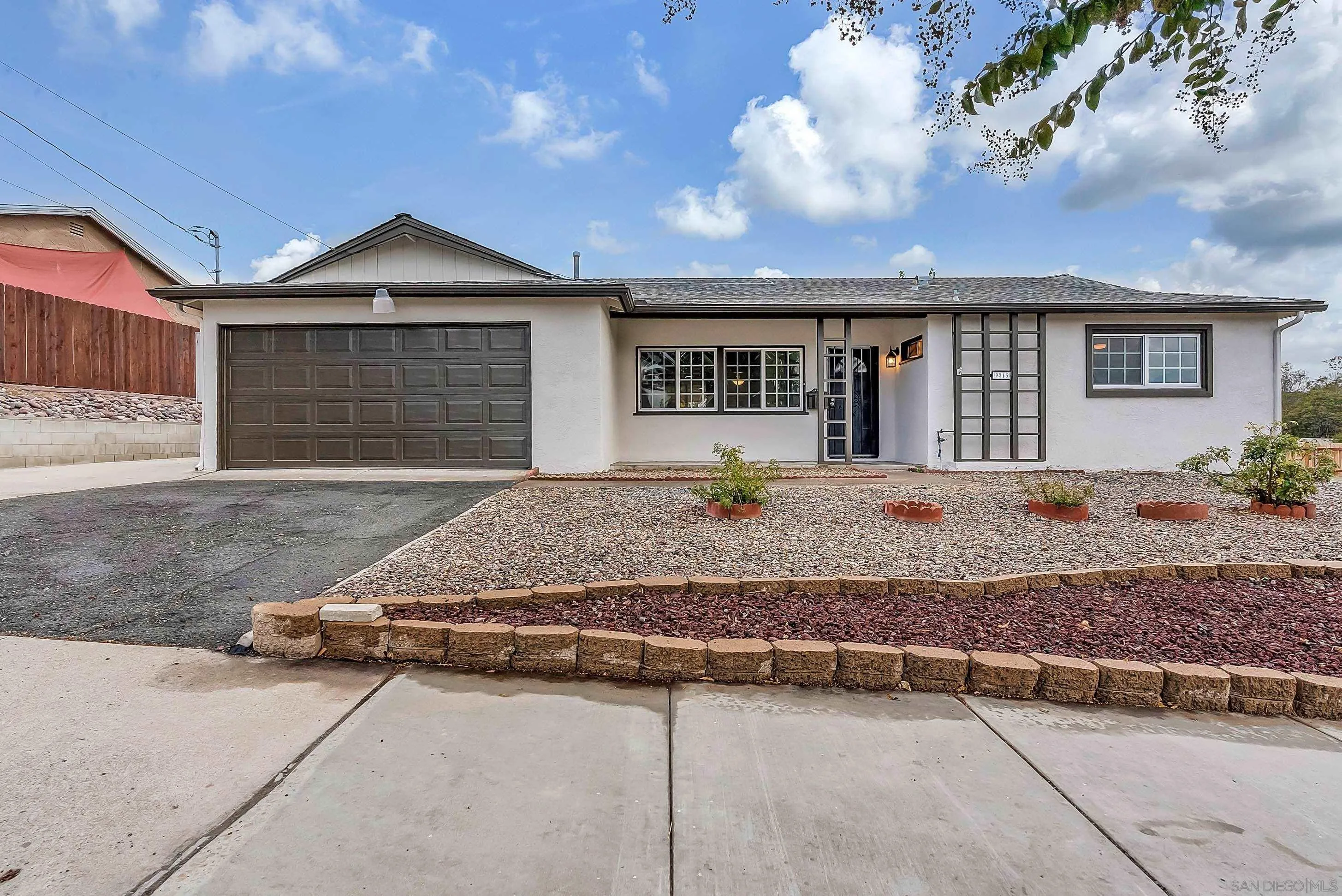 9215 Lake Canyon Road Santee, CA 92071 - Photo 2 of 18 a front view of a house with a yard and garage