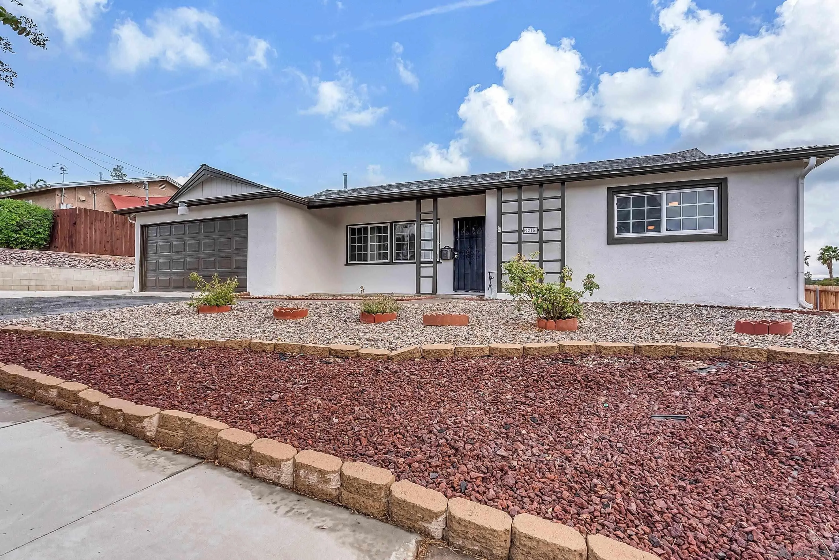 9215 Lake Canyon Road Santee, CA 92071 - Photo 3 of 18 a front view of a house with garden