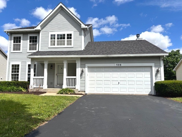 508 Ramsden Road Plano, IL 60545 - Photo 2 of 20 a front view of a house with a yard and garage