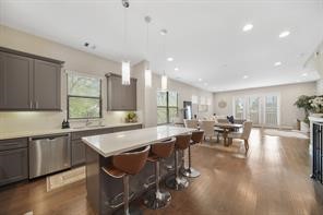 1824 Bonner Street Houston, TX 77007 - Photo 20 of 39 a large dining hall with stainless steel appliances granite countertop a sink a stove a dining table and chairs with wooden floor