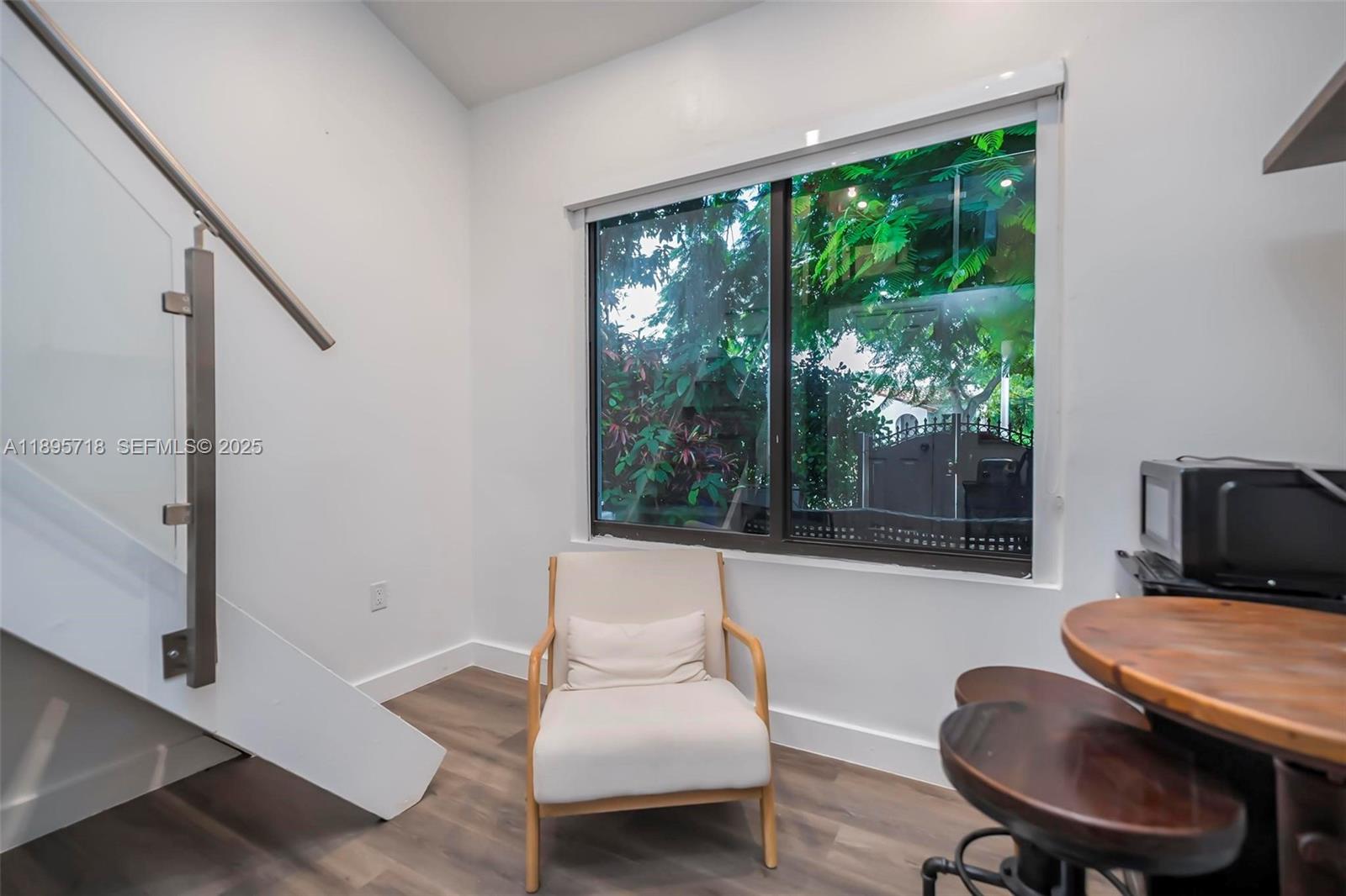 870 Northeast 82nd Street, Unit 2 Miami, FL 33138 - Photo 4 of 8 a living room with furniture and a window