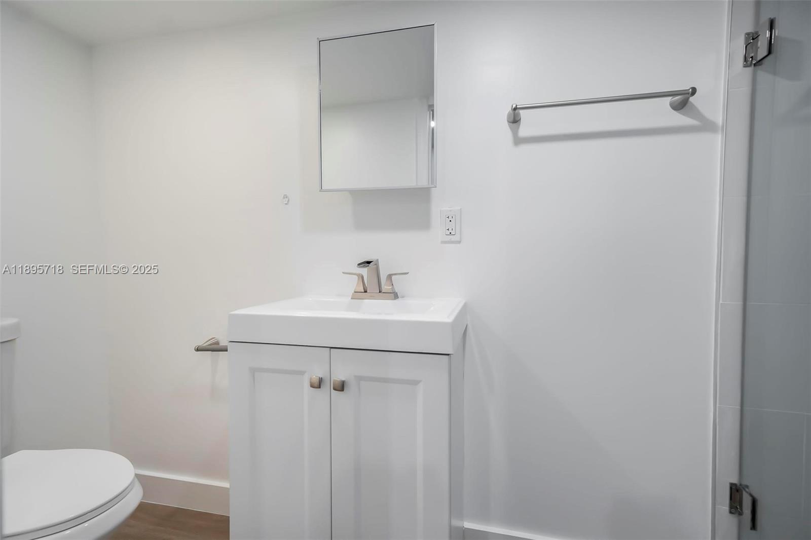 870 Northeast 82nd Street, Unit 2 Miami, FL 33138 - Photo 7 of 8 a bathroom with a sink a toilet and shower