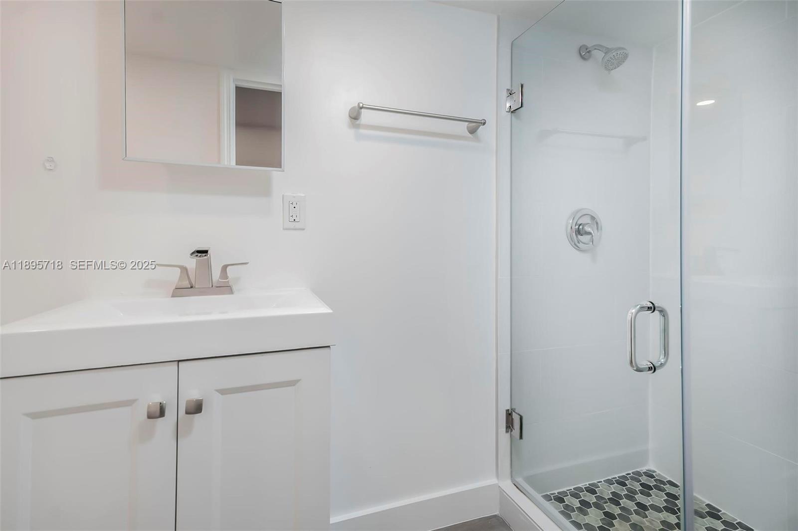 870 Northeast 82nd Street, Unit 2 Miami, FL 33138 - Photo 8 of 8 a bathroom with a shower sink and toilet