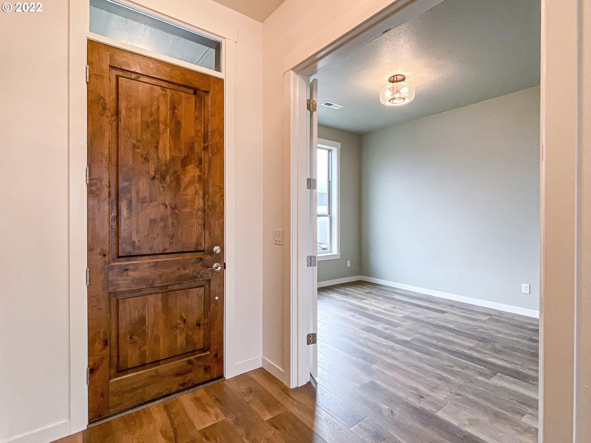 817 South Goose Loop Ridgefield, WA 98642 - Photo 25 of 31 an empty room with wooden floor cabinet and windows