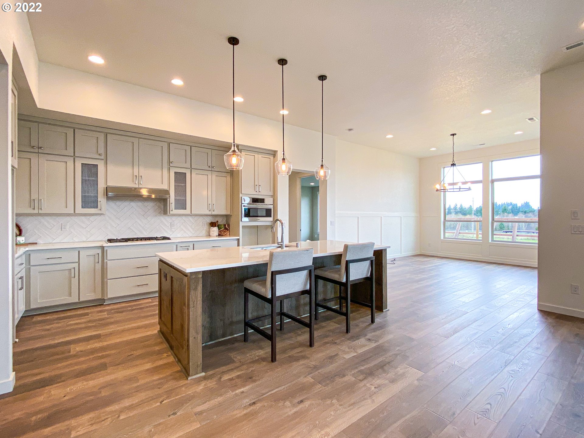 817 South Goose Loop Ridgefield, WA 98642 - Photo 3 of 31 a large kitchen with kitchen island a sink table and chairs