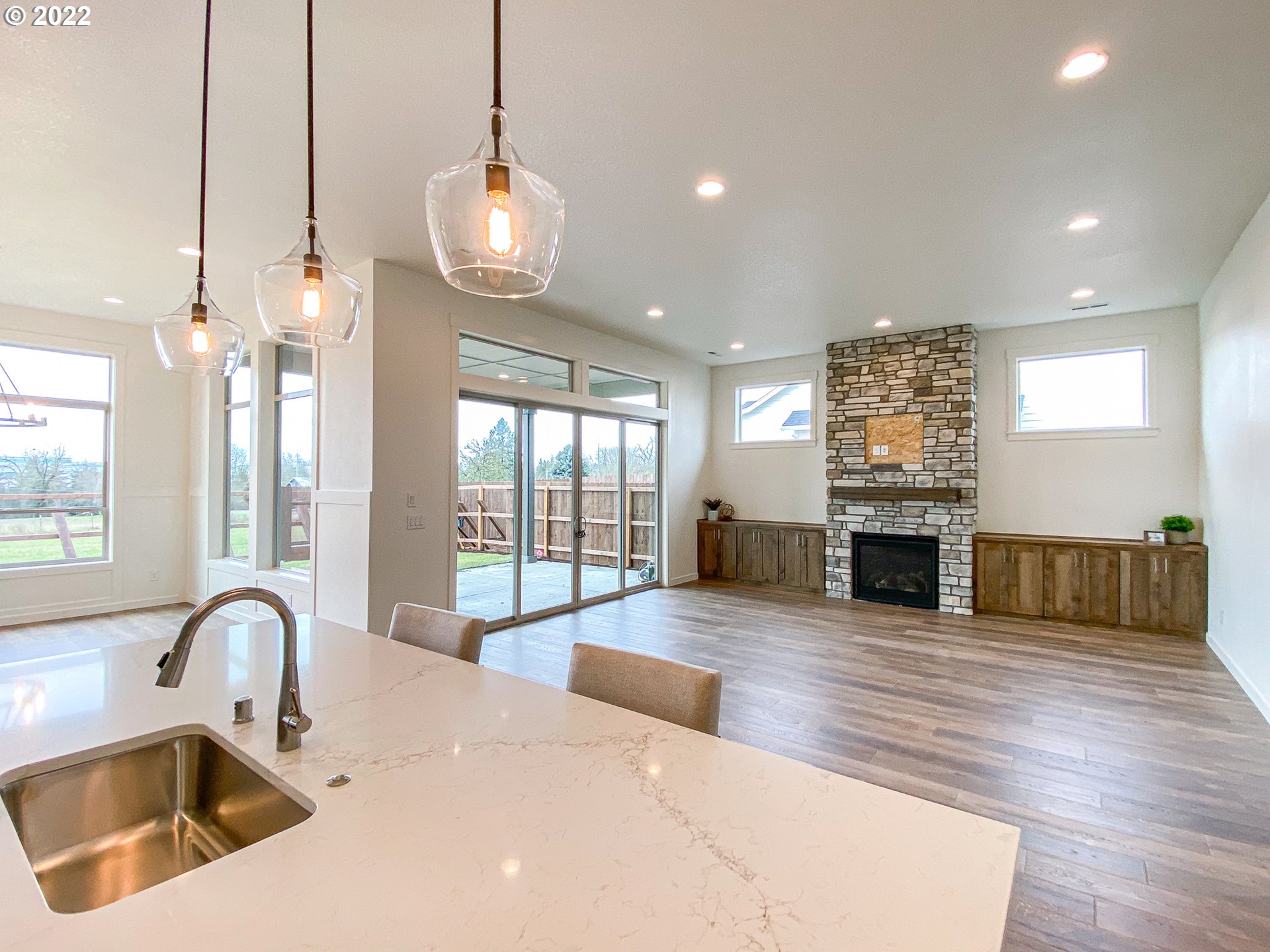 817 South Goose Loop Ridgefield, WA 98642 - Photo 9 of 31 a large white kitchen with a large window and chandelier