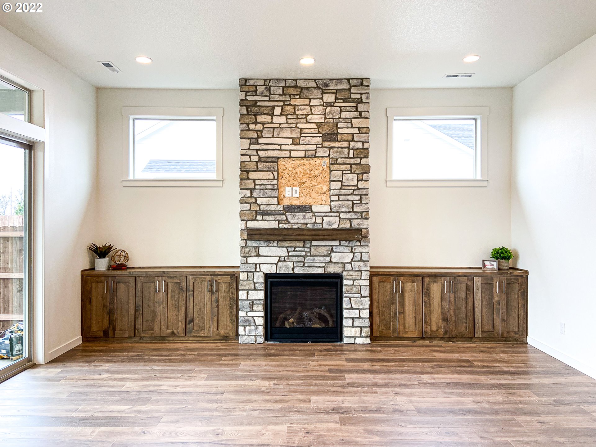 817 South Goose Loop Ridgefield, WA 98642 - Photo 10 of 31 an empty room with wooden floor fireplace and windows