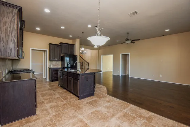 a kitchen with kitchen island a counter top space appliances and cabinets
