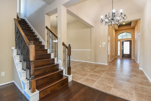 a view of an entryway with wooden floor and staircase
