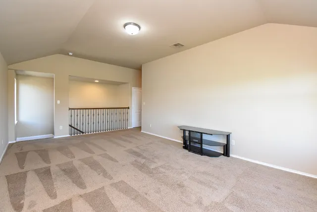 a view of a livingroom with wooden cabinets