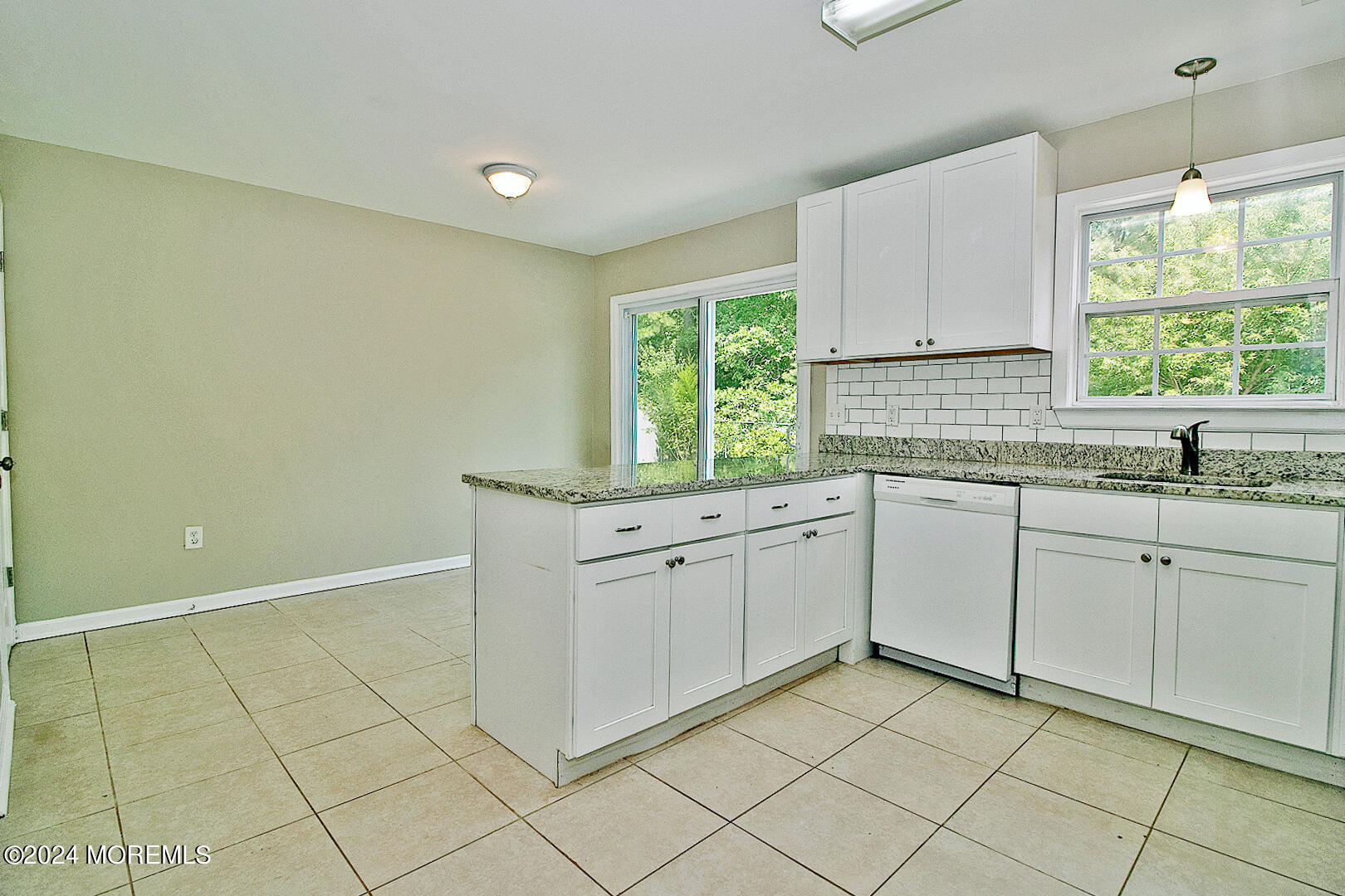 79 Timberline Road Bayville, NJ 08721 - Photo 16 of 40 a kitchen with white cabinets appliances a sink and a window