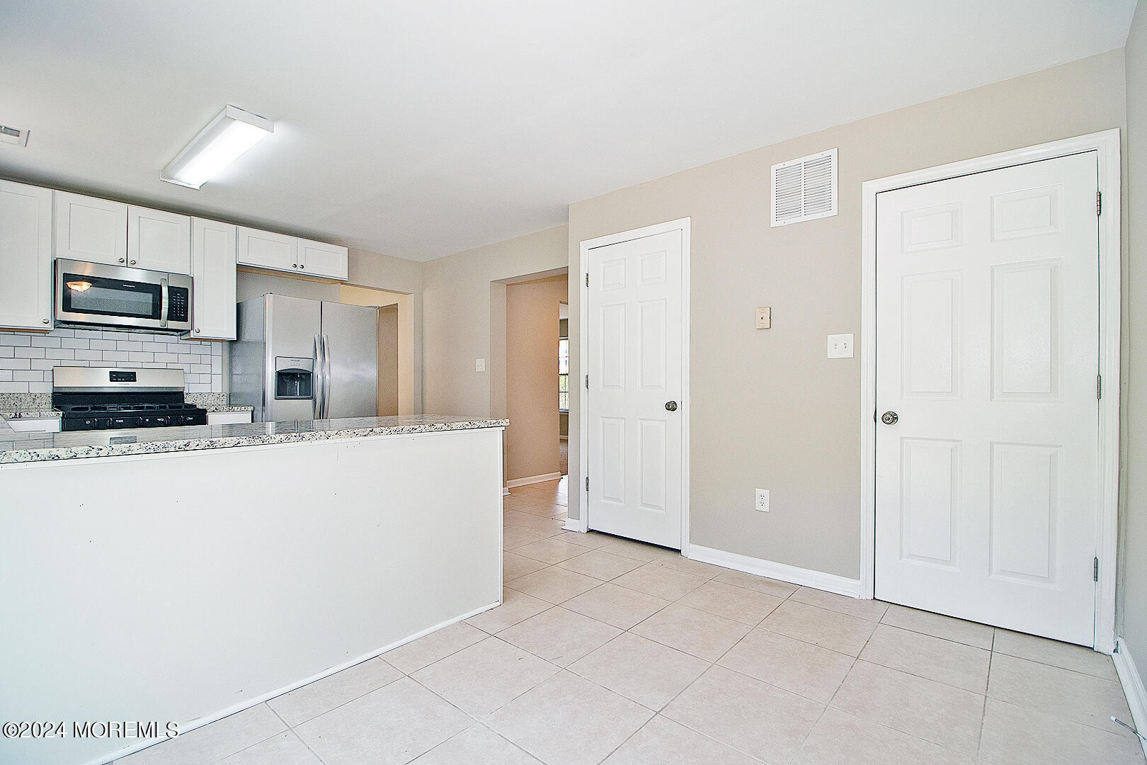 79 Timberline Road Bayville, NJ 08721 - Photo 23 of 40 a kitchen with stainless steel appliances granite countertop a refrigerator a stove top oven a sink and dishwasher