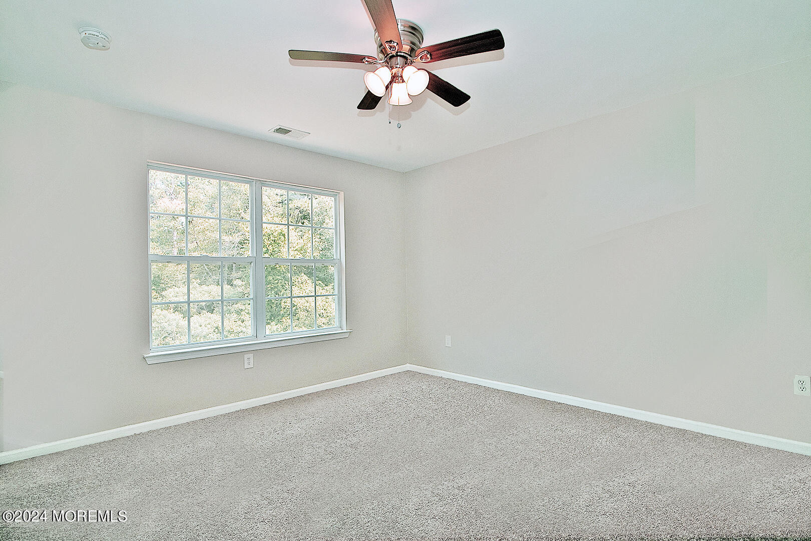79 Timberline Road Bayville, NJ 08721 - Photo 37 of 40 an empty room with a window and a fan