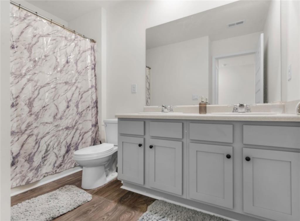 160 Grafton Street Hampton, GA 30228 - Photo 11 of 15 a bathroom with a toilet sink and mirror