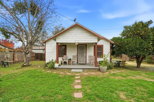 a front view of house with yard and outdoor seating