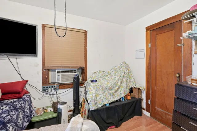 a bedroom with a bed and large windows