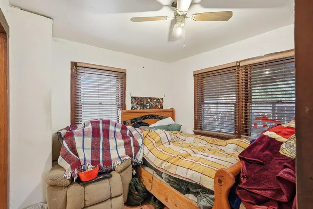 a bedroom with a bed and a window