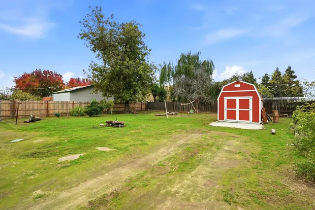 a view of a house with a backyard