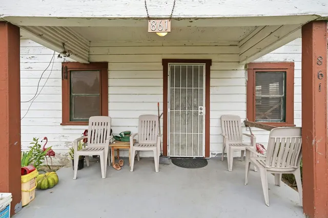 a view of a two chairs in front of house