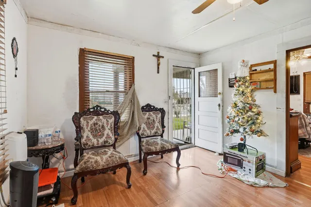 a living room with furniture and wooden floor