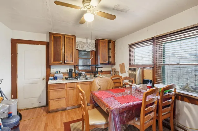 a view of a dining room with furniture and a window