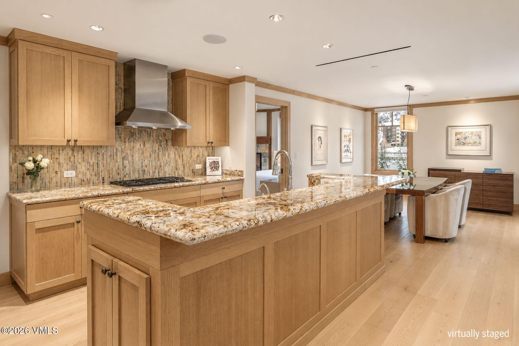 1 Vail Road, Unit 9204 Vail, CO 81657 - Photo 7 of 27 a kitchen with kitchen island granite countertop a sink and counter space