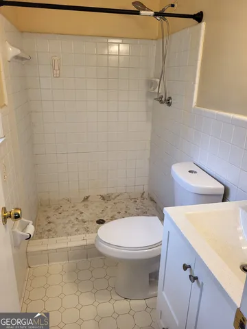 a bathroom with a toilet a sink and shower