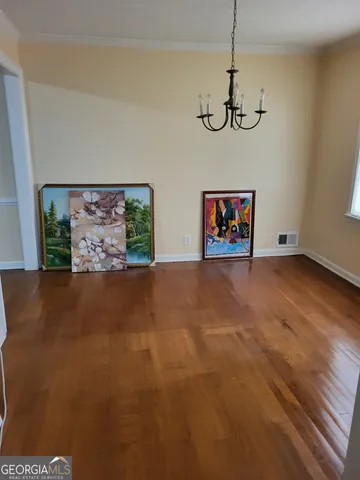 a view of a room with painting on the wall