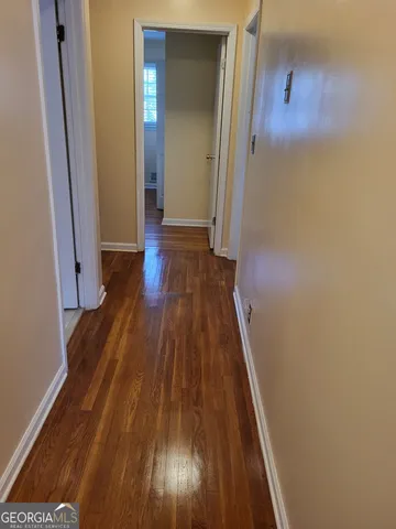 a view of a hallway with wooden floor