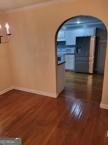 a view of a kitchen with a sink and a refrigerator