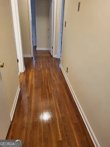 a view of a hallway with wooden floor