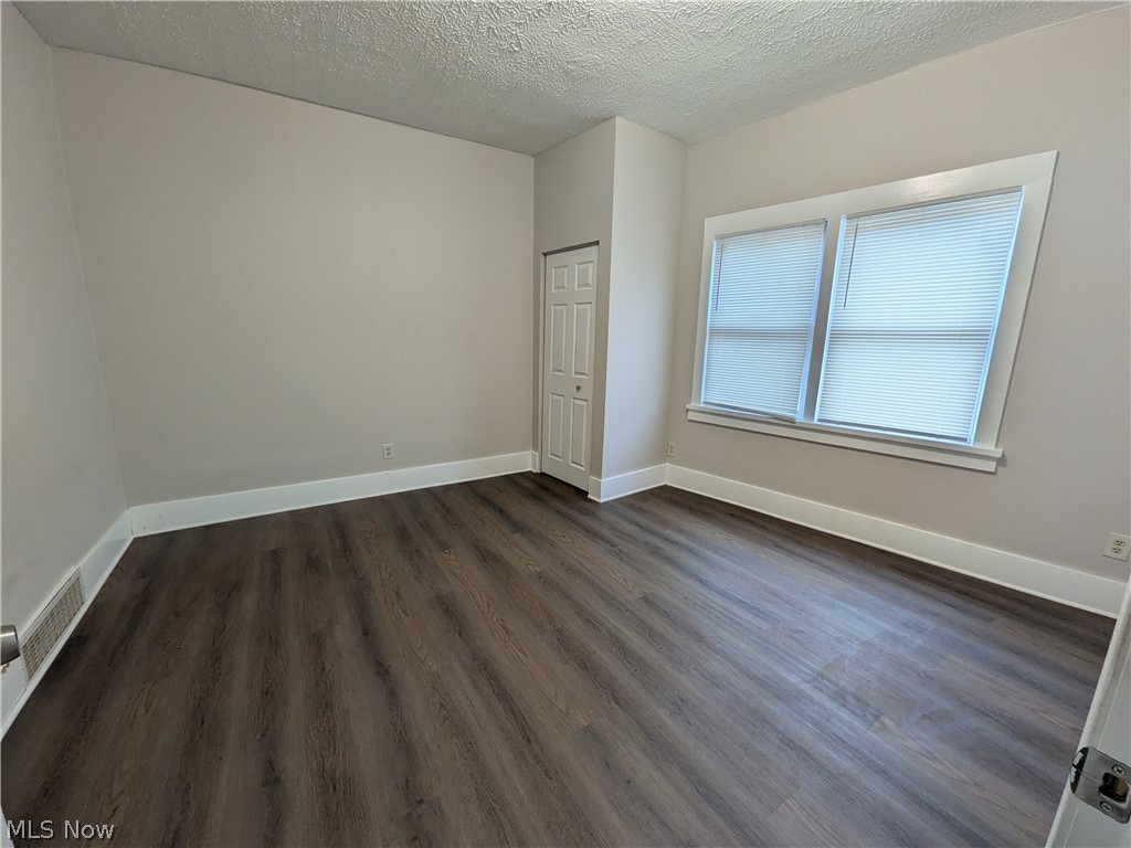 1881 Manchester Road, Unit 1 Akron, OH 44314 - Photo 6 of 44 1881 Manchester Rd, Akron, OH 44314 Unit #1 ground floor access and living. Welcome to this spacious 2-bedroom, 1-bathroom first-floor generous and remodeled apartment in the Kenmore neighborhood of Akron, offering a great amount of comfortable living space. This move-in ready apartment features LVP flooring throughout, a spacious living room, room for dining, separate kitchen with a gas range and stainless steel refrigerator, two bedrooms, and a full private bathroom which has a convenient step-in shower. Large windows provide natural light, while ample closets offer plenty of storage. Enjoy off-street parking and a backyard with a picnic table and small firepit, providing a pleasant outdoor space to relax and enjoy for the buildings tenants.
