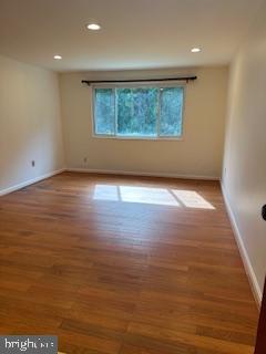 3831 Hamilton Street, Unit F102 Hyattsville, MD 20781 - Photo 2 of 12 an empty room with wooden floor and windows