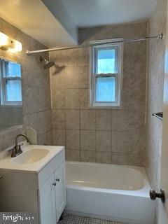 3831 Hamilton Street, Unit F102 Hyattsville, MD 20781 - Photo 7 of 12 a white bath tub sitting next to a white sink and vanity