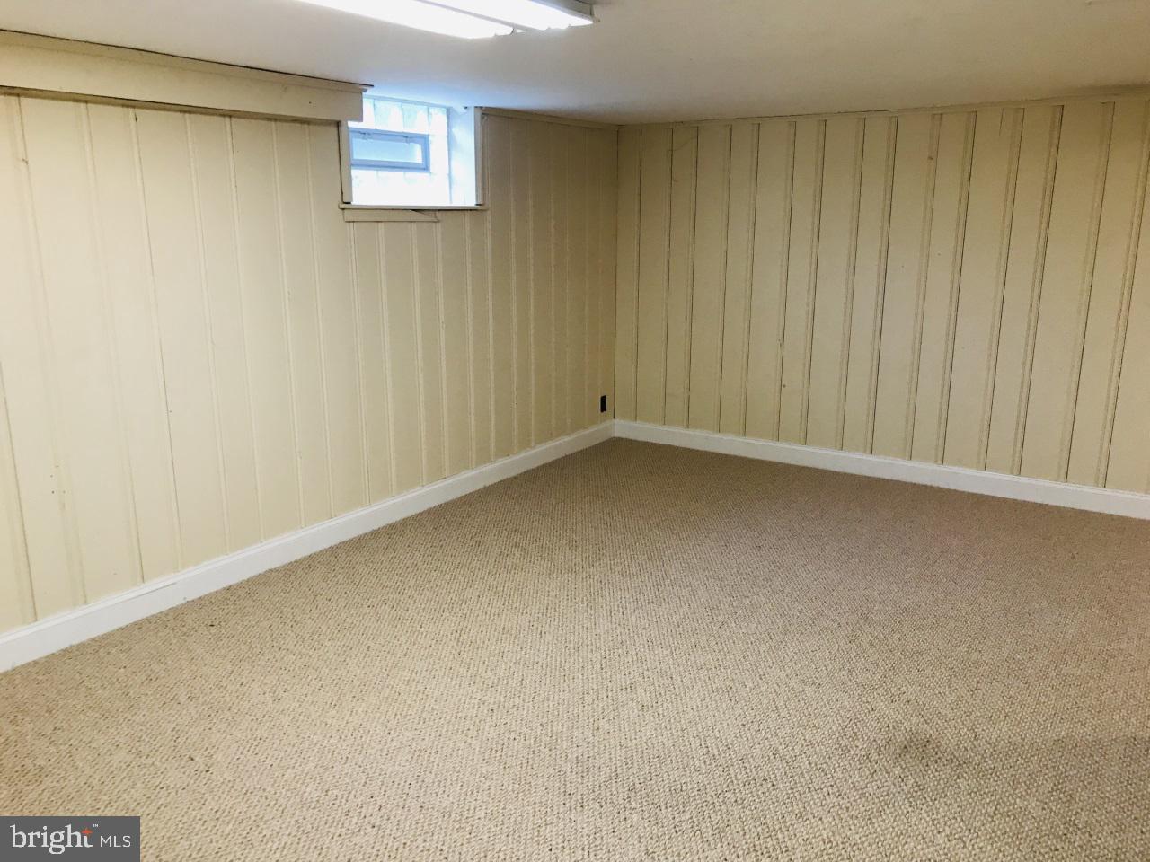 7504 Rocksham Drive Baltimore, MD 21286 - Photo 20 of 24 Basement clubroom. with flush nearby.