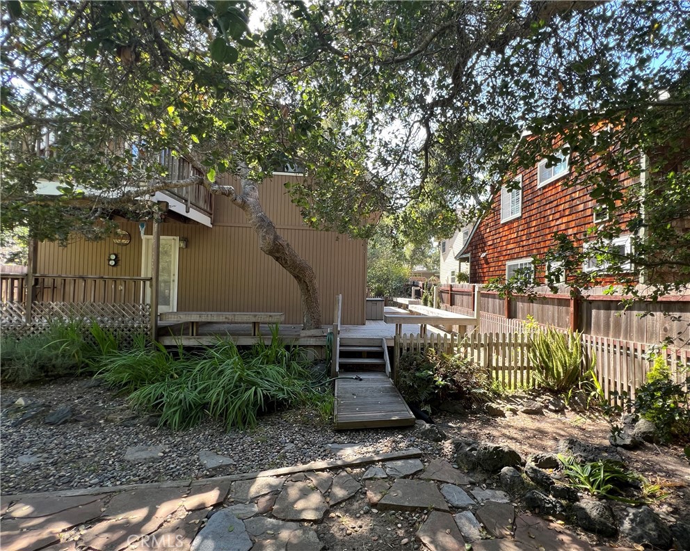 1530 Emerson Road Cambria, CA 93428 - Photo 50 of 54 Back yard looking deck and entrance to downstairs bedroom